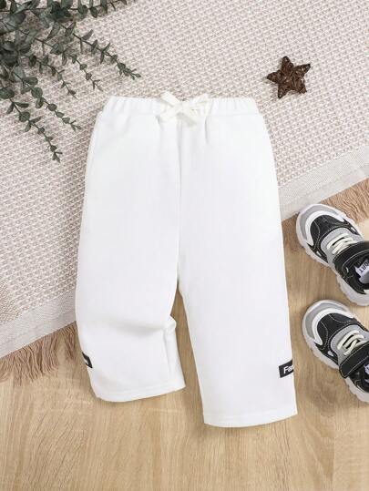 SHEIN بنطلون تفاصيل مرقع بعبارة رباط خصر للاولاد الاطفال