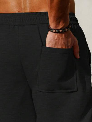 Manfinity Homme سروال رجالي فضفاض بخصر ذو رباط لون سادة للارتداء اليومي بجيوب، ربيع/صيف
