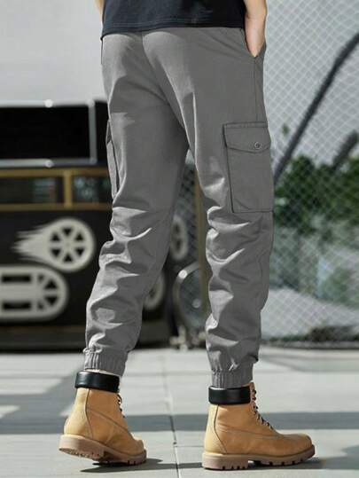 Manfinity Homme بنطلون كاجوال رجالي ذو لون سادة، قصة ضيقة، مزود بأربطة للكاحل و جيوب للبضائع