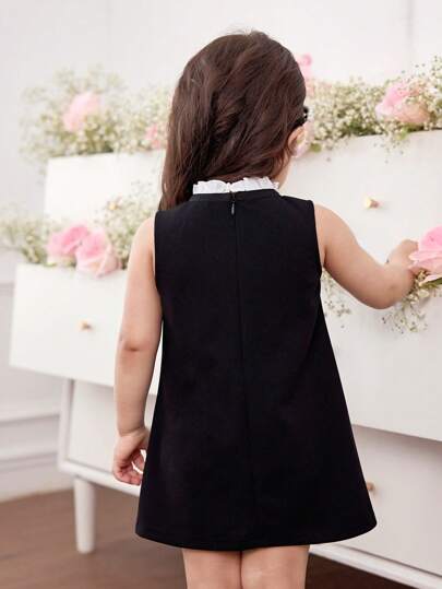 فساتين بيبي فستان أنيق وجذاب لطفلة بتصميم لوني باللون الأبيض والأسود محلى بفيونكة