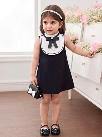 فساتين بيبي فستان أنيق وجذاب لطفلة بتصميم لوني باللون الأبيض والأسود محلى بفيونكة