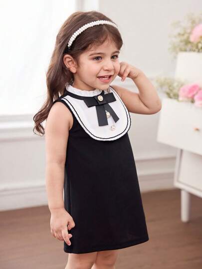 فساتين بيبي فستان أنيق وجذاب لطفلة بتصميم لوني باللون الأبيض والأسود محلى بفيونكة