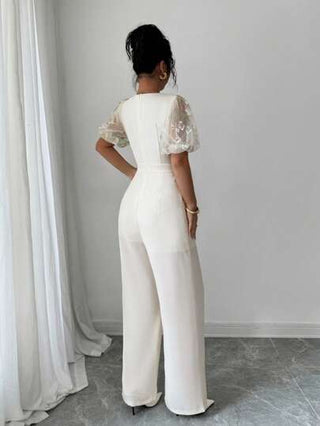 Modelyn العيد جمبسوت قصيرة الأكمام ذات رجل واسع للنساء، مرقعه بطرز معدنية و شبكية