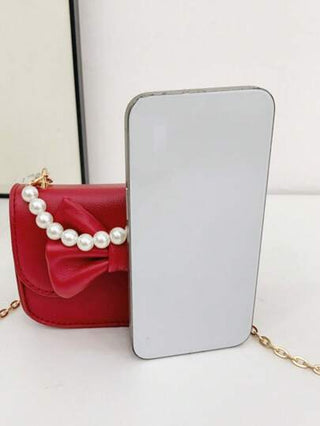 قطعة واحدة حقيبة طفلة صغيرة أنيقة إصدار كوريا نسخة PU بطبعة عقدة الفراشة لطيف، لون سادة، قابلة للطي ذات محفظة صغيرة، مناسبة لجميع المناسبات، يد متدلية زخرفية باللؤلؤ الاصطناعي، خفيفة غير متطرفة في الاختيار، مناسبة للخارج أو للعب أو التنقل، هدية مثالية للأ