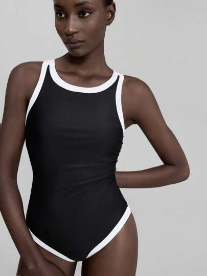 مايوه حريمي قطعة واحدة Ontre ملابس سباحة نسائية موديل جديد 2022، بدلة سباحة قطعة واحدة، باللون الأسود مع تباين لون المشمش، تصميم ظهر متقاطع ، كاجوال وأنيق ، ملابس شاطئ