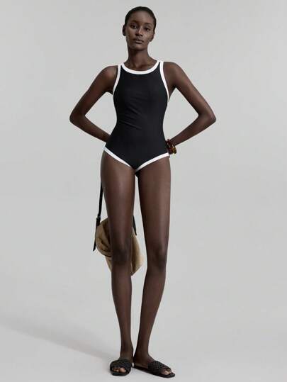 مايوه حريمي قطعة واحدة Ontre ملابس سباحة نسائية موديل جديد 2022، بدلة سباحة قطعة واحدة، باللون الأسود مع تباين لون المشمش، تصميم ظهر متقاطع ، كاجوال وأنيق ، ملابس شاطئ