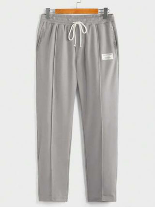 SHEIN طقم من قطعتين: ملابس علوية أكمام قصيرة للفتيان المراهقين بتصميم مريح وفضفاض بلون سادة، وبنطال بساق مستقيم