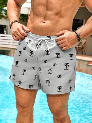 Manfinity Swimmode شورتات بشريط خصر مطبوعة برسوم أشجار النخيل ذات جيوب للرجال، طراز هاواي