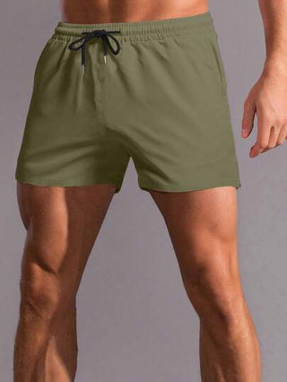 Manfinity Homme شورت رجالي صيفي فضفاض مطاطي الخصر بلون سادة
