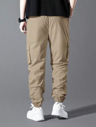 Manfinity Homme البنطلونات الرياضية السفلية الرجالية ذات اللون الواحد والجيب الكبير