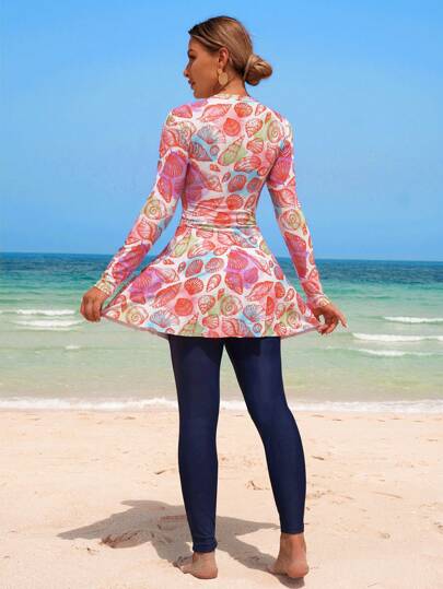 Swim Shayni مجموعة من 2 قطعة، ملابس علوية بأكمام طويلة ذات طبعات عشوائية من الصدف الملونة على قاعدة بيضاء وفستان A-line مع سروال ضيق على الطريقة الشرق أوسطية، بيكيني