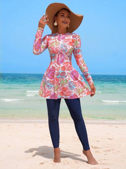 Swim Shayni مجموعة من 2 قطعة، ملابس علوية بأكمام طويلة ذات طبعات عشوائية من الصدف الملونة على قاعدة بيضاء وفستان A-line مع سروال ضيق على الطريقة الشرق أوسطية، بيكيني