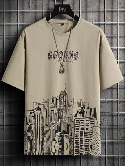 Manfinity Homme تي شيرت رجالي مطبوع عليه حرف وبناء، طراز 2000