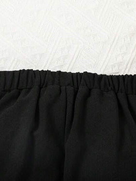 SHEIN بنطلون أسود للفتاة الشابة بتصميم جريء مع زخرفة سلسلة معدنية