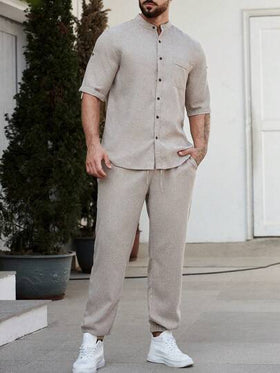 Manfinity Homme قميص ذو أكمام مطوية واسع ولون صلب للرجال
