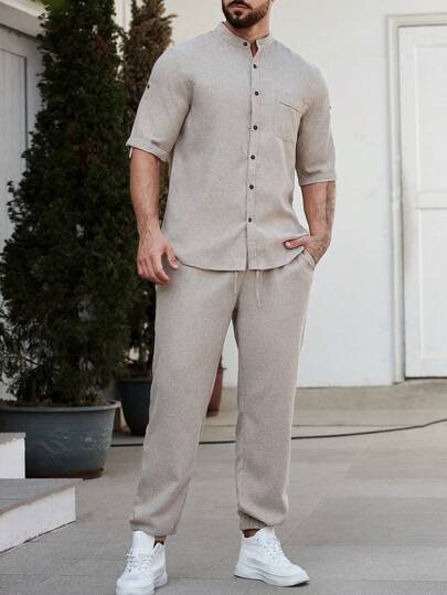 Manfinity Homme قميص ذو أكمام مطوية واسع ولون صلب للرجال