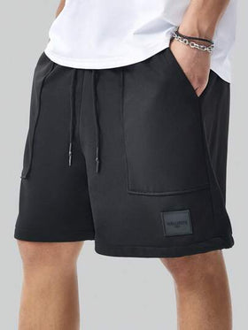 Manfinity Homme شورت رياضي رجالي فضفاض بجيوب واسعة أحادي اللون، مطبوع برسوم حرفية بسيطة، هدية مناسبة للزوج أو الحبيب