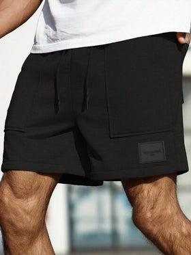 Manfinity Homme شورت رياضي رجالي فضفاض بجيوب واسعة أحادي اللون، مطبوع برسوم حرفية بسيطة، هدية مناسبة للزوج أو الحبيب