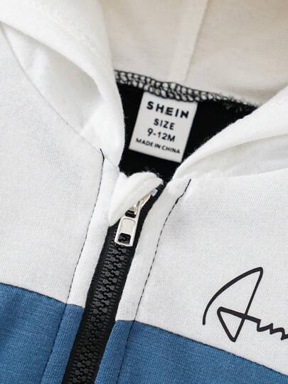 SHEIN مجموعة ملابس ولادية من طقم ملابس علوية ذات سحاب مطبوع بخطوط ملونة مع غطاء رأس وبنطلون خصر مطاطي للشارع بمظهر عصري 2 قطعة