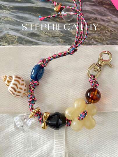 STEPHIECATHY سوار يدوي مضفر بالحبال الملون مزين بأشكال الأصداف والزهور وخرز ملون، قلادة وسلسلة مفاتيح مناسبة لإكسسوارات الحقائب والهواتف وأكسسوارات حفلة عيد الحب