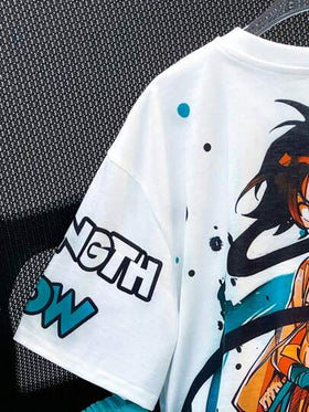 SHEIN مجموعة من قطعتين (بلوزة وشورت) بموديل الشباب الألطف بنمط الرسومات الكرتونية وطباعة الجرافيتي، نصف أكمام، خصر مرن، مناسب للخريف والربيع والصيف، للألعاب الخارجية والمدرسة والطراز الشارعي والسهرات والراحة المنزلية