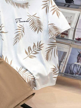 SHEIN مجموعة 2 قطعة تيشرت برسومات أوراق استوائية وشورت بخصر رباط ،ملابس الربيع للمراهقين، ملابس أولاد المراهقين ، سترات أولاد المراهقين، عودة المدرسة للربيع