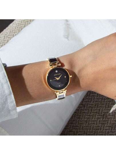 Anne Klein ساعة سوار للنساء بإطار ذهبي وأسود مرصعة بالراين ستون، ساعة أنيقة وكاجوال هدية للسيدات، AK/1980BKGB