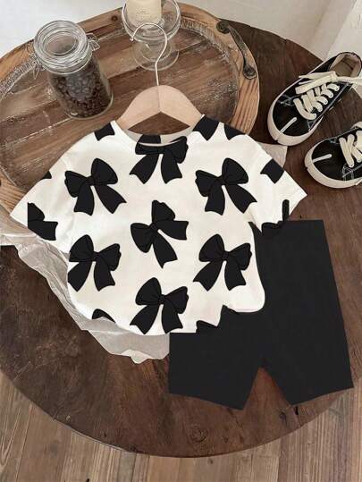 طقم ملابس للبنات الرضع من تي شيرت قصير الأكمام بياقة مستديرة مطبوع عليه الفيونكة ، وشورت أسيل مضفر قطعتين، ملابس منزلية بنقشة فيونكة سوداء ملابس بنات رضع كاجوال
