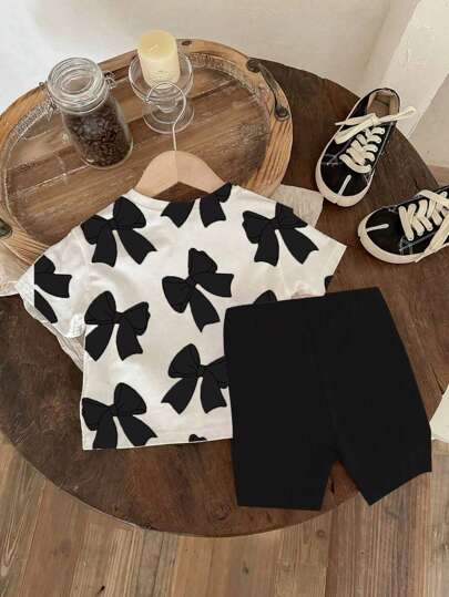 طقم ملابس للبنات الرضع من تي شيرت قصير الأكمام بياقة مستديرة مطبوع عليه الفيونكة ، وشورت أسيل مضفر قطعتين، ملابس منزلية بنقشة فيونكة سوداء ملابس بنات رضع كاجوال