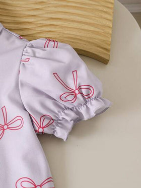 SHEIN Genkimix Kids طقم من 2 قطعة، بلوزة كم قصير منتفخ ذات طبعة فيونكة مع بنطال، مناسب للفتيات الصغيرات