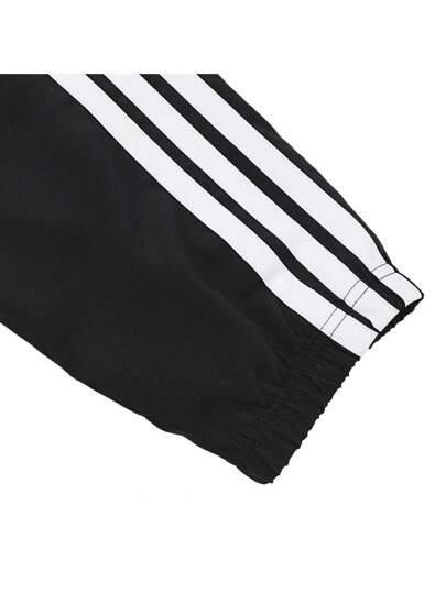 Adidas بناطيل قماشية للبنين بارتداد الألوان والخطوط المنسوجة 2025 JD6500
