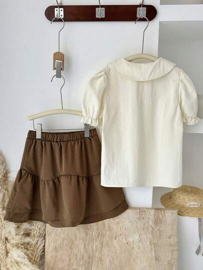 girls-sets Vintaside Kids طقم للبنات من قميص قصير الأكمام مناسب للصيف مع تنورة غربية عصرية وجذابة مثالي للموسم الصيفي. التصميم عملي وأنيق، يوفر الدفء والأناقة للخارج أو وقت الراحة في المنزل