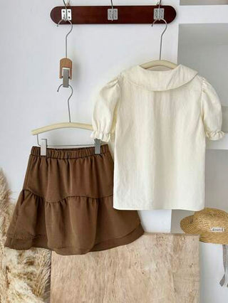girls-sets Vintaside Kids طقم للبنات من قميص قصير الأكمام مناسب للصيف مع تنورة غربية عصرية وجذابة مثالي للموسم الصيفي. التصميم عملي وأنيق، يوفر الدفء والأناقة للخارج أو وقت الراحة في المنزل