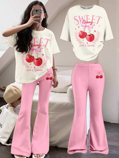 girls-sets طقم بنطلون قصير وتيشرت برسومات فتاة مراهقة مع فيونكة حلوة و طبعة الكرز، باللون الوردي، مناسب للصيف