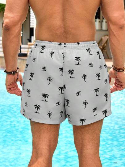 Manfinity Swimmode شورتات بشريط خصر مطبوعة برسوم أشجار النخيل ذات جيوب للرجال، طراز هاواي