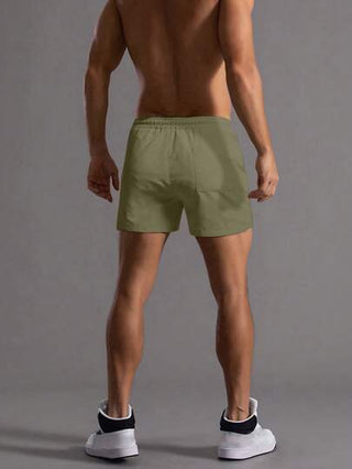 Manfinity Homme شورت رجالي صيفي فضفاض مطاطي الخصر بلون سادة