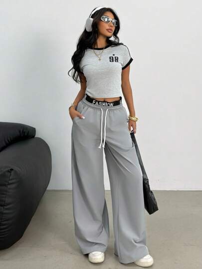 SHEIN بدلة رياضية للبنات المراهقات بطقم قميص أكمام قصيرة باللونين الأسود والرمادي بحواف مضادة وبنطلون فضفاض للساق ذو قطعتين بألوان عصرية