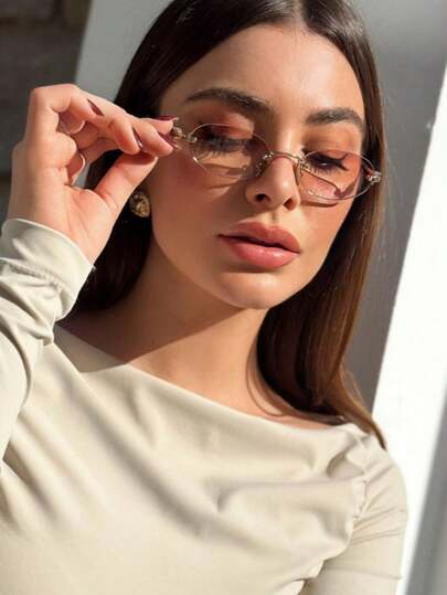 نظارات شمسية أنيقة بإطار معدني بدون إطار بشكل بيضاوي للنساء باللون الرمادي الداكن، مناسبة للارتداء اليومي والإطلالات الأنيقة في الصيف والشاطئ والسفر والأنشطة الخارجية وعودة المدرسة، بتصميم بيضاوي