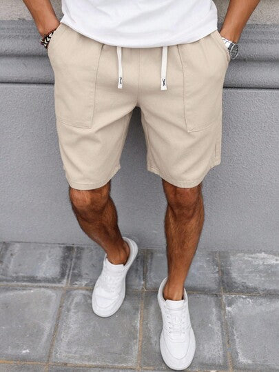 Manfinity Homme شورت جينز رجالي مريح بخصر مطاطي ولون سادة ممزقة باللون الكريمي، مناسب لفصلي الربيع والصيف والاستجمام
