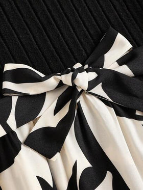 SHEIN فستان بناتي ماكسي أنيق بأكمام منفوخة مطبوع بزهور على خلفية لون أسود، تفاصيل ربطة الخلف وأكمام كبيرة الحجم، فستان بناتي فاخر وعتيق