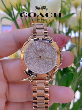 Coach ساعة تاتوم النسائية بمينا ذهبي وردي