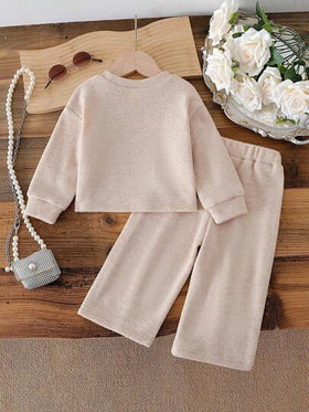 SHEIN طقم بناتي لعمر 0-3 سنوات، كنزة صوفية طويلة الأكمام بياقة دائرية أنيقة مزينة بفيونكة، مع بنطلون مصنوع من الأقمشة المحبوكة باللون المشمشي، مناسب للخروجات والمناسبات العادية وحفلات عيد الميلاد