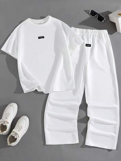SHEIN مجموعة بنطلون وتيشيرت بأكمام قصيرة وياقة دائرية بتصميم كاجوال وشارع مناسب للمراهقات، مريح ومتعدد الاستخدامات للتنقل والمدرسة والاستخدام اليومي والعطلات والتدريب والحفلات، مناسب للربيع والصيف