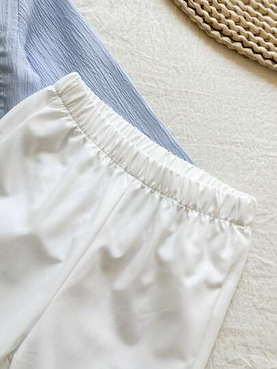 SHEIN Vintaside Kids طقم قطعتين للأطفال الصبيان يتميز بقميص أكمام طويلة ذو ياقة عالية بنقشة جاكارد أزرق وبنطلون أبيض ذو ساق مستقيمة، مناسب للربيع والخريف، ويصلح للخروجات المدرسية اليومية، حضور الحفلات، الاسترخاء في المنزل، والمناسبات الرسمية