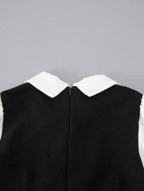 SHEIN هذه بدلة بقطعة واحدة مناسبة للفتيات المراهقات، تتميز بتصميم ياقة مرتفعة، أكمام طويلة، وزخارف أزرار على صفين. لها طراز واسع الساق مرتاح. مصنوعة من مزيج من الأقمشة السوداء والبيضاء. هذه البدلة مثالية للارتداء اليومي والتنقل في الحرم الجامعي، ومناسبة ل