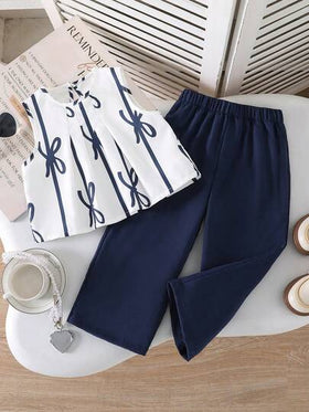 SHEIN مجموعة فتاة صغيرة 2 قطعة تتكون من ملابس علوية كشكشة بدون أكمام مزينة بفيونكة ثلاثية الأبعاد وبنطلون قصير، مناسبة للارتداء اليومي في الربيع والصيف