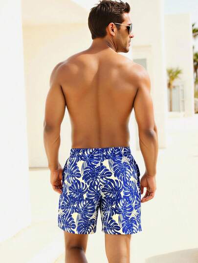 Manfinity Swimmode شورت شاطئ للرجال بخصر مرن وجيوب مع طباعة نباتات استوائية