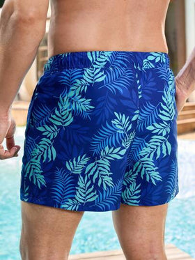 Manfinity Swimmode شورت شاطئ رجالي مطبوع بالنباتات مع جيب مائل وخصر رباط، شورت شاطئ رجالي مطابق للزوجين مع خصر رباط وجيب أمامي مربوط، شورت سباحة رجالي بطبعة أشجار النخيل باللون الأزرق، شورت سباحة رجالي باللون الأزرق، ملابس شاطئ رجالية