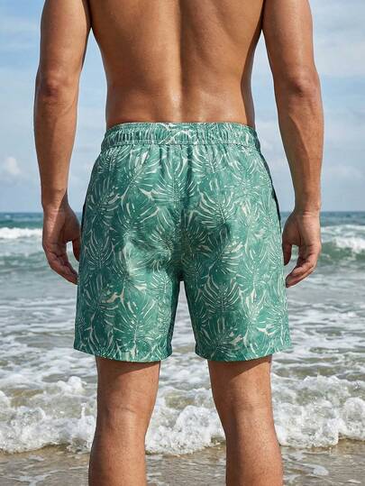 Manfinity Swimmode شورت كاجوال للشاطئ للرجال بخصر مرن وجيوب بطبعة نباتات استوائية