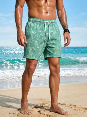 Manfinity Swimmode شورت كاجوال للشاطئ للرجال بخصر مرن وجيوب بطبعة نباتات استوائية